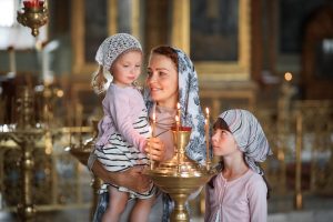 young mother her little blond caucasian daughter with candles orthodox russian church 7 - Дети и храм: создайте ребёнку праздник!