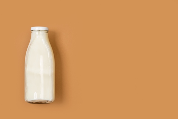 a bottle of milk on a brown background in a top view - Домашний йогурт