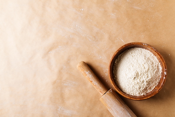 bakery brown beige background with roll and flour flat lay - Постный бездрожжевой лаваш