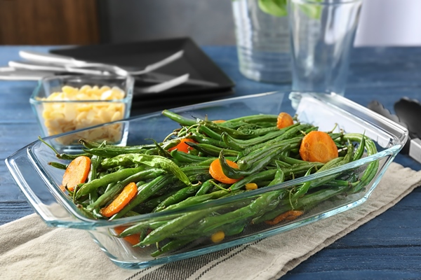 delicious green beans and carrot slices in glass baking dish on table - Запеканки в духовке: правила приготовления