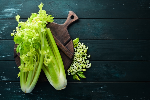 fresh green celery stalk on a black background healthy food top view free space for your - Кабачковая икра с сельдереем