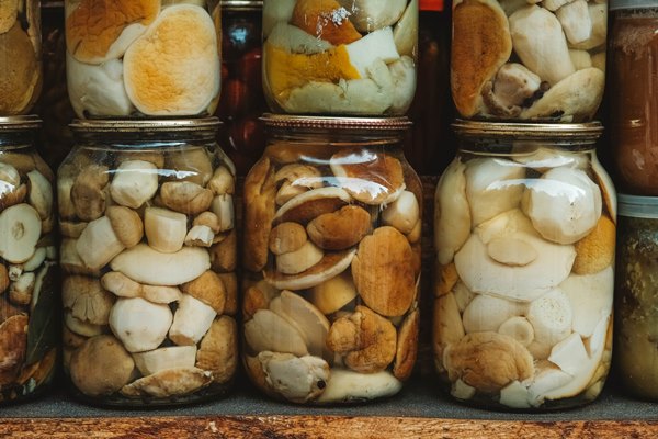 marinated wild mushrooms in glass jars copy empty space for - Жареные опята на зиму