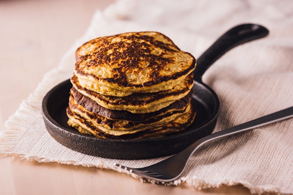 pile of homemade pancakes freshly made on a small pan ready to eat - Чечевичные постные блинцы