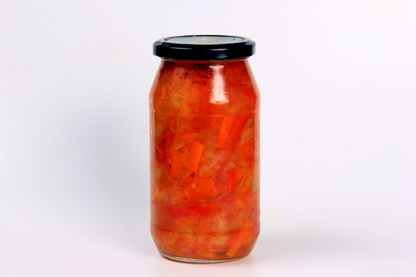 preparation of canned lecho canned sweet bell peppers in a glass jar on a white background - Лечо двухцветное с душистыми травами