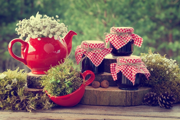 red teapot tea cup and jars of healthy jam wedding decorations in rustic style - Варенье из костяники