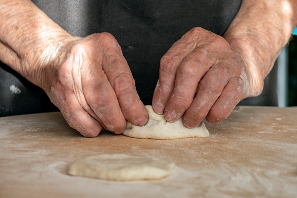 the old woman s overworked hands are making pies out of dough - Рыбные расстегаи