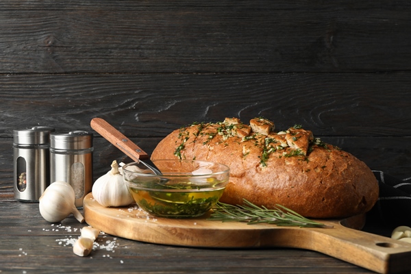 board with garlic bread and oil on wooden space for - Салат из зелени сельдерея с ореховым соусом