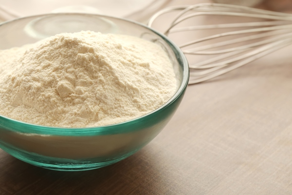 bowl with flour and ingredients for dough on table - Постные пресные блинцы на картофельном отваре