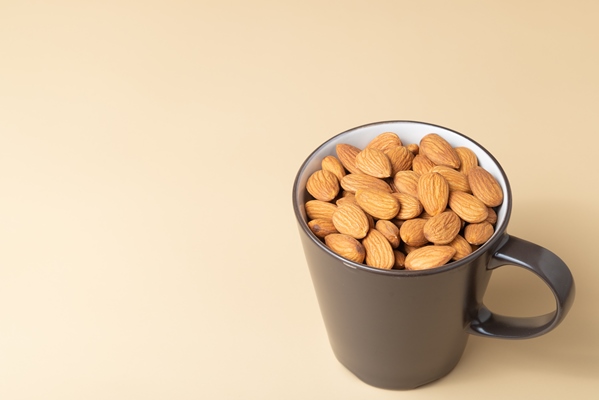 brown almond in a coffee mug with free copy space - Марципаны на розовой воде