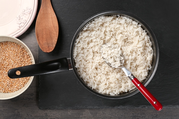 cooked rice in saucepan with spoon 1 - Постные блинчики с рисом и изюмом