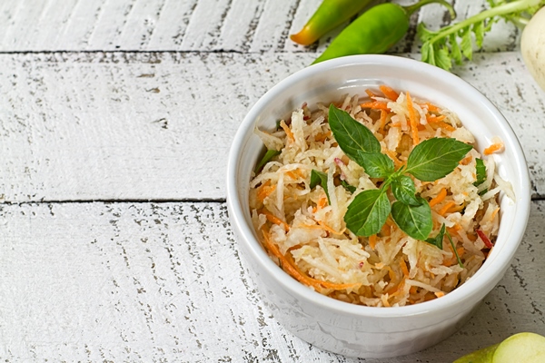 daikon white radish salad with carrots and apples om white wooden table healthy eating - Салат «Освежающий»
