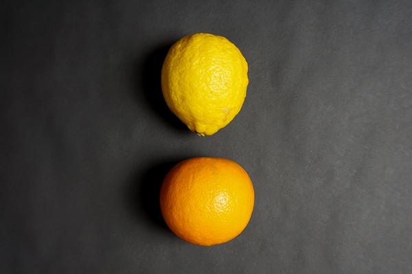 fresh lemon and orange fruits with black background - Постные гречневые блины с джемом
