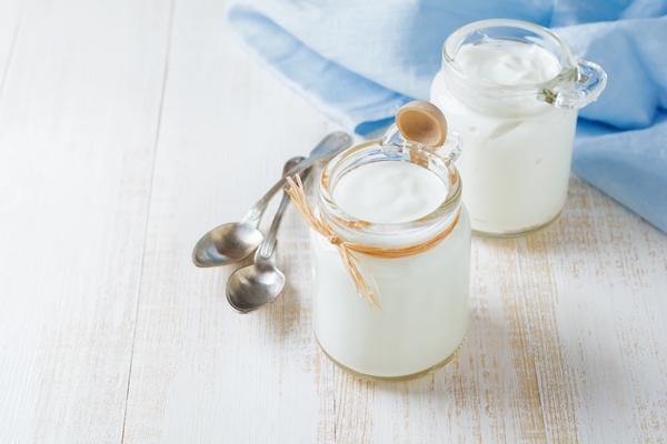 fresh natural yogurt in a glass jar on light wooden table healthy food for breakfast milk dairy product selective focus - Пасха красная старинная