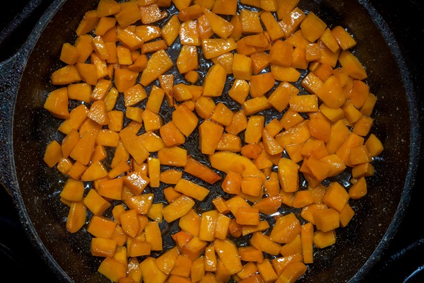 fried pumpkin cut into bars on a cast iron pan top view close up - Постные блинчики с карамельной тыквой