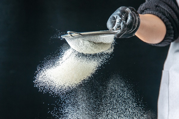 front view female cook pouring white flour into the pan on a dark egg job bakery hotcake pastry kitchen cuisine dough - Постные блинцы с какао