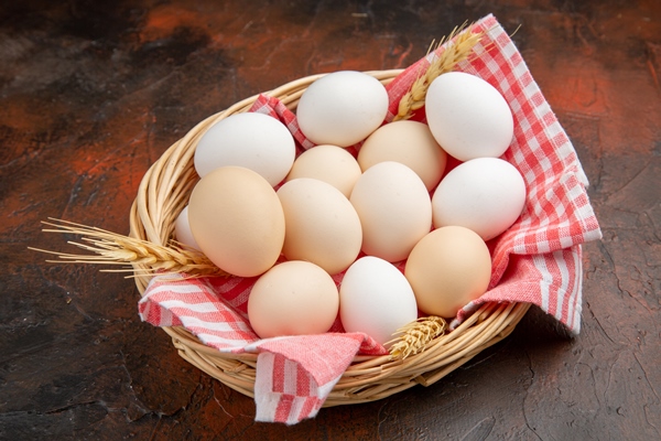 front view white chicken eggs inside basket with towel on a dark surface - Овощная запеканка с курицей