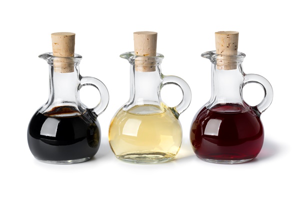 glass bottles with different types of vinegar - Салат с грибами на зиму