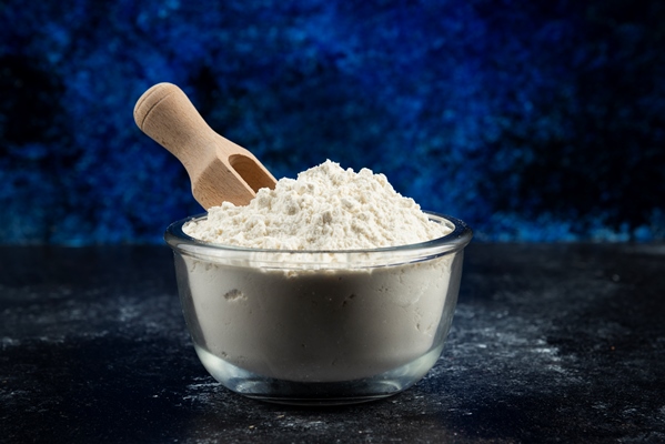 glass bowl of flour on blue - Постные блинчики с карамельной тыквой