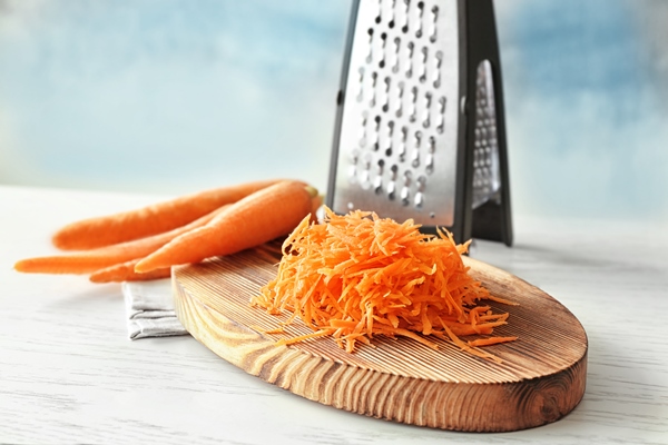 heap of grated carrot on wooden board 1 - Грибная аджика