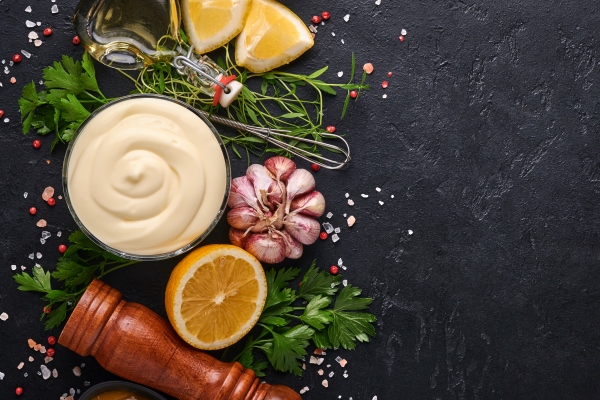 homemade mayonnaise sauce and ingredients lemon eggs olive oil spices and herbs black background copy space food cooking background top view - Салат «Южная ночь»