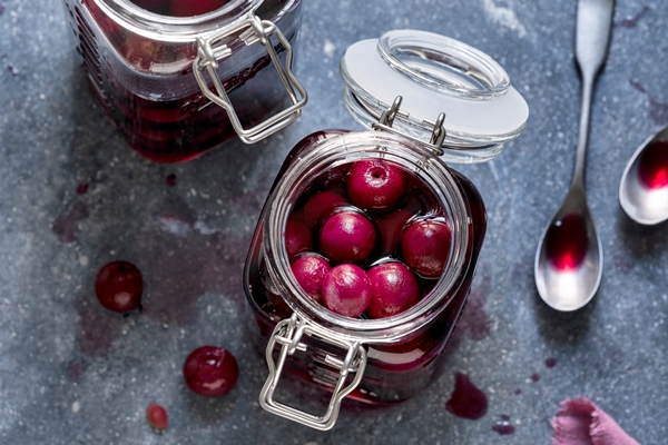 maraschino cherry in glass jars flat lay food ingredient - Консервированная вишня с косточками