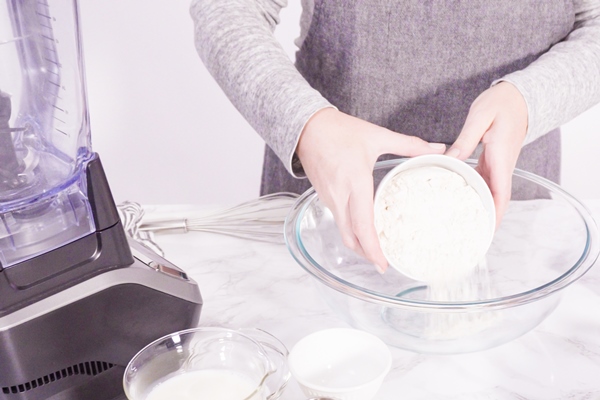 mixing ingredient in a glass mixing bowl to make the crepes batter - Постные блинцы из миндальной муки