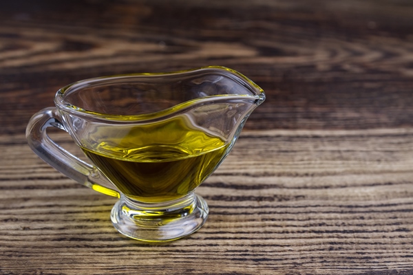 olive oil in a glass gravy boat vegetable oil on a wooden table 1 - Постные блинцы с апельсиновым соком