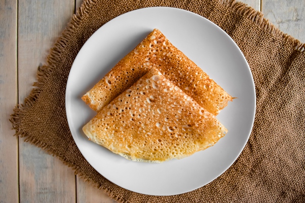 pancakes on a white plate on a linen background russian traditional food crepes for the holiday maslenitsa - Постные блинцы на рассоле