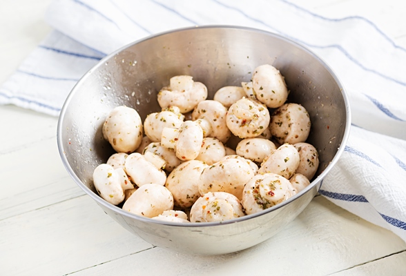 raw champignon mushrooms in a bowl on white rustic background prepared for baking - Постный грибной суп с вермишелью