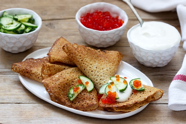 rye and whole grain pancakes served with sour cream caviar and cucumbers rustic style - Постные ржаные блинцы на минеральной воде