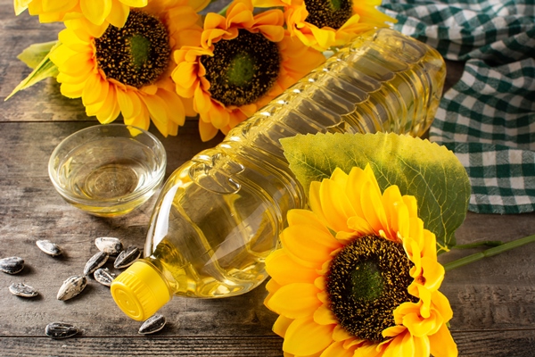 sunflower oil plastic bottle on wooden table - Постные блинчики с сиропом из сухофруктов