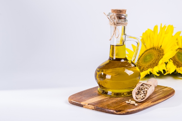 sunflower seed oil in glass bottle on white surface - Блинчики"Чайные" постные с мёдом