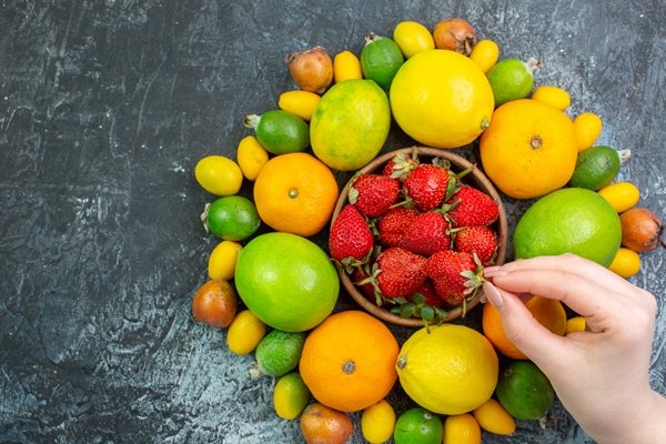 top view fresh fruits composition with red strawberries on grey background - Фруктовый салат