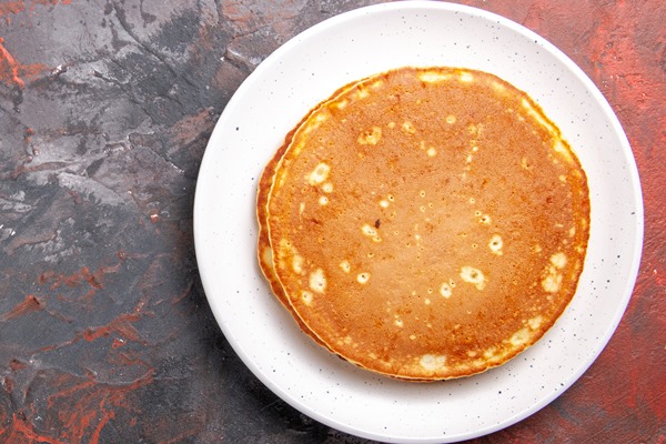 top view on delicious pancakes on plate - Постные блинчики с гречкой, грибами и овощами