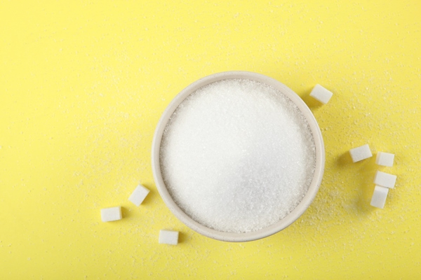 white sugar on the table on a light background closeup 1 - Рябина, протёртая с сахаром