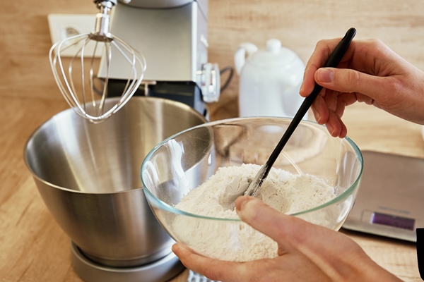 woman mixed ingredients in kitchen mixer bowl homemade cooking - Постные блинчики на чае с пряной начинкой