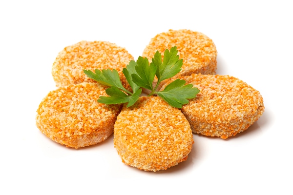 a pile of cooked chicken nuggets isolated on a white background - Морковные постные котлеты