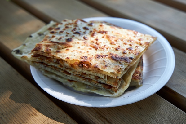 appetizing crispy turkish tortillas with filling lie on a plate - Плацинды постные