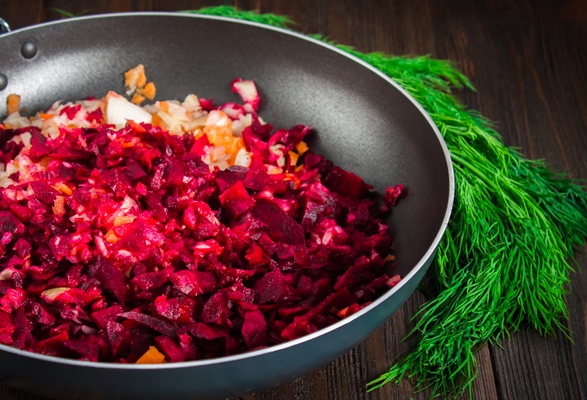 carrots beets and onions in a frying pan around dill on a brown wooden background 1 - Постная фаршированная свёкла под соусом