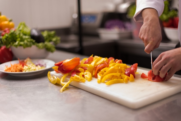 chef cutting fresh and delicious vegetables for cooking or salad - Постный плов с черносливом