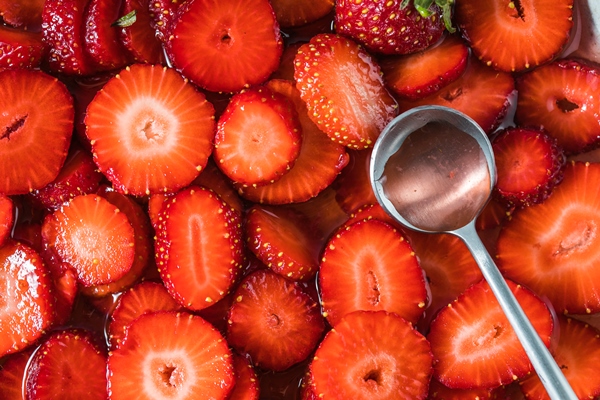 closeup of strawberry in a saucepan preparation of strawberry jelly marmalade or sauce - Клубничный мармелад