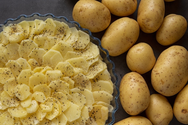 cooking cooking baked potatoes in the oven potato casserole slices of fresh potatoes laid in a baking dish produce - Картофельные ломтики с грибами