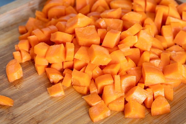 diced carrots on wooden chopping board healthy food - Постный грибной суп охлаждённый