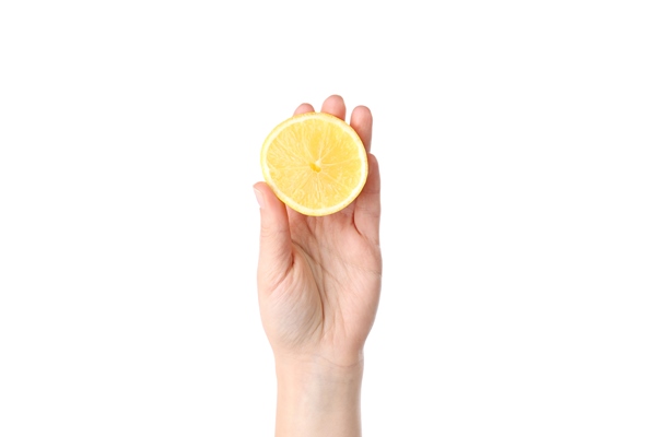 female hand holds half of lemon isolated on white background - Салат из моркови, мёда и орехов