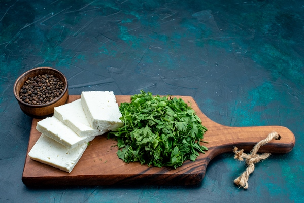 front view white cheese with fresh greens on the dark blue background - Горячий сэндвич с сыром и зеленью