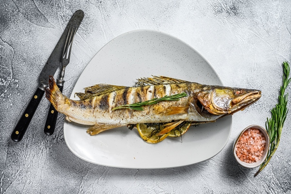 grilled zander walleye fish with herbs and lemon on a plate gray wooden background top view - Винегрет с белой фасолью