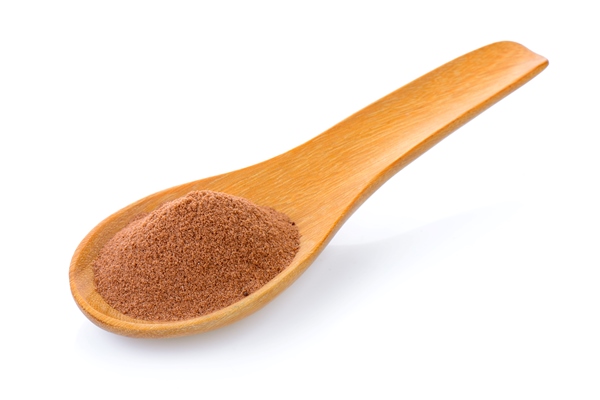 malt extract in wood spoon on white background - Солодовое сусло