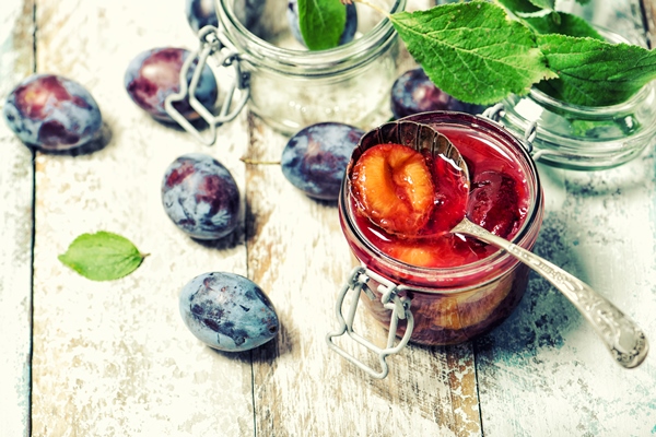 plums jam with fresh fruits on wooden background vintage style toned picture - Маседуан из слив