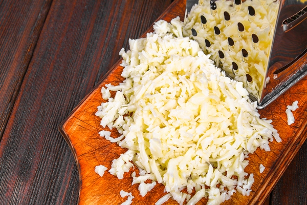 portion of grated cheddar cheese on rustic wooden table 1 - Сырный суп