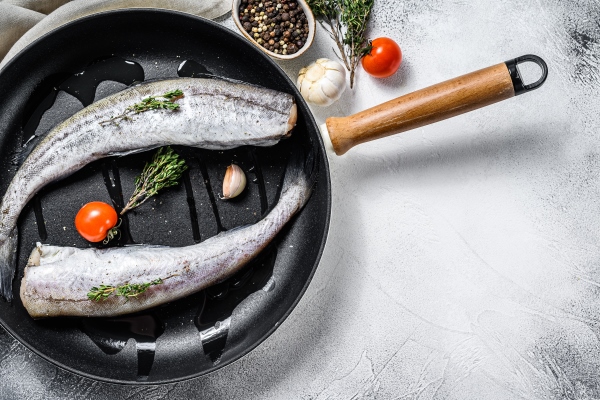 raw pollock fish in a pan - Навага жареная, постный стол